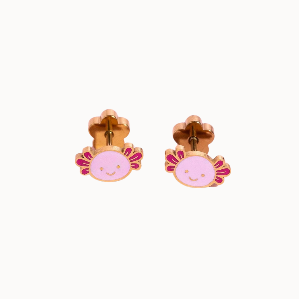 A pair of gold-plated stud earrings featuring a cute pink axolotl face with magenta accents, shown against a plain off-white background.