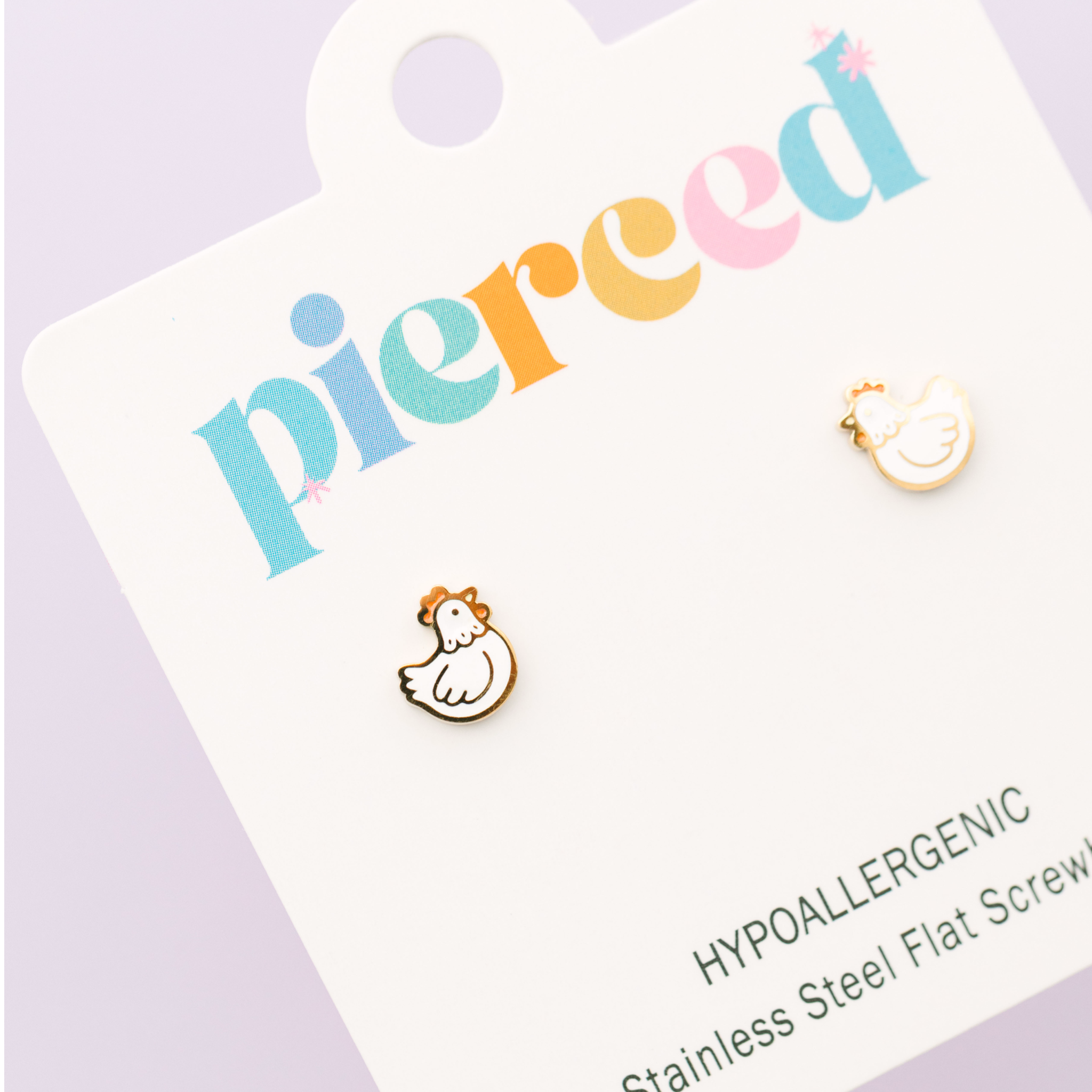 Earring card with 'pierceed' branding and two small earrings on a light purple background