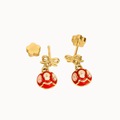 A pair of gold and red dangle earrings on a plain white background. Each earring features a gold bow charm and a round red enamel drop with gold floral details.