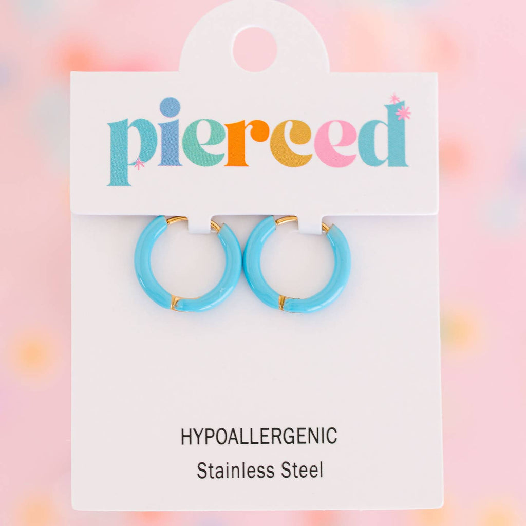 Turquoise hoop earrings on a 'pierceed' branded card with a colorful background