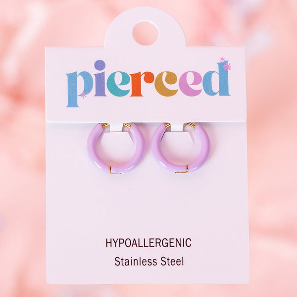 Pair of purple hoop earrings on a 'pierced' branded card with a pink blurred background