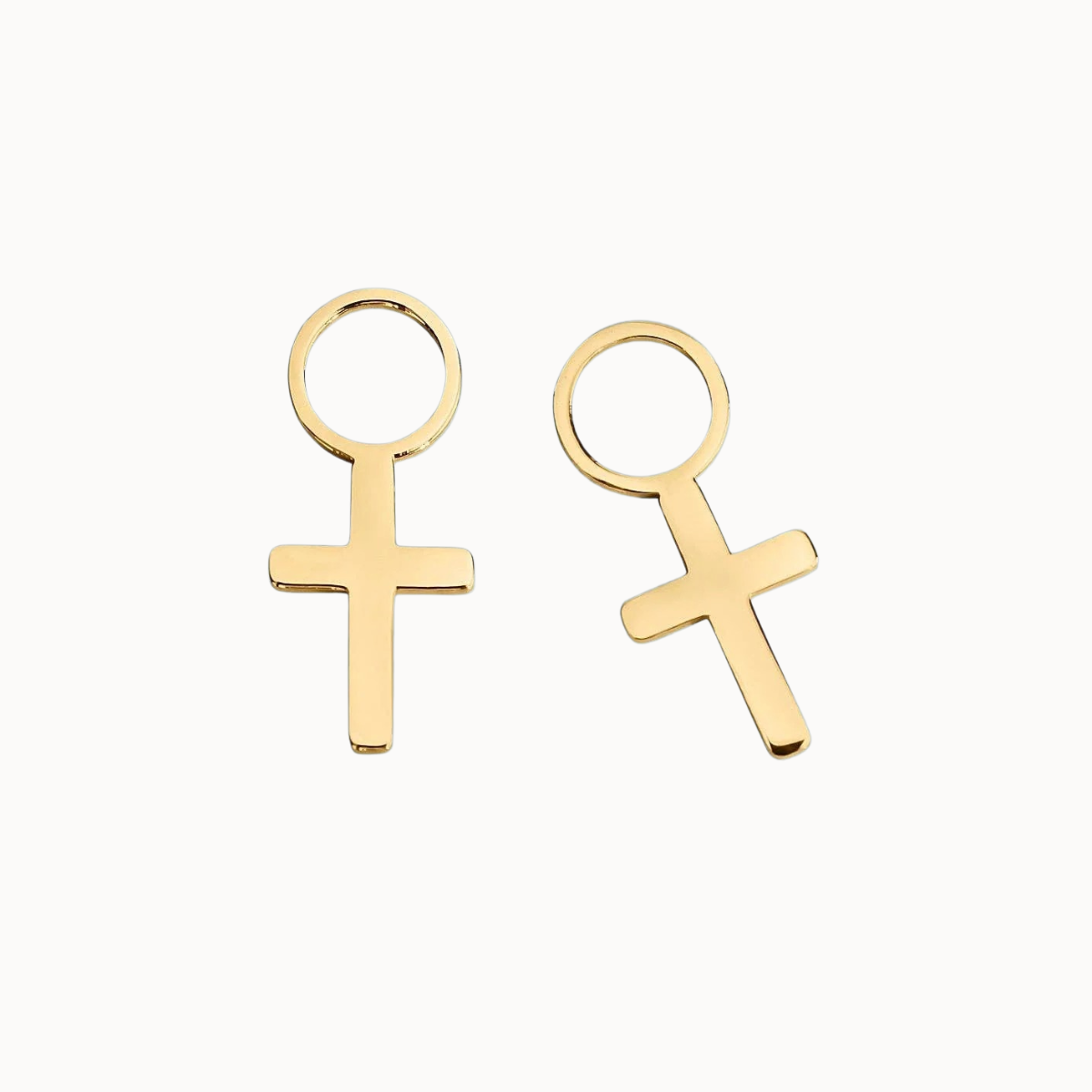 A pair of gold-plated cross stud earrings with a flat, polished cross design and a circular top loop, shown on a clean off-white background.