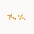A pair of small gold cross stud earrings on a plain off-white background.