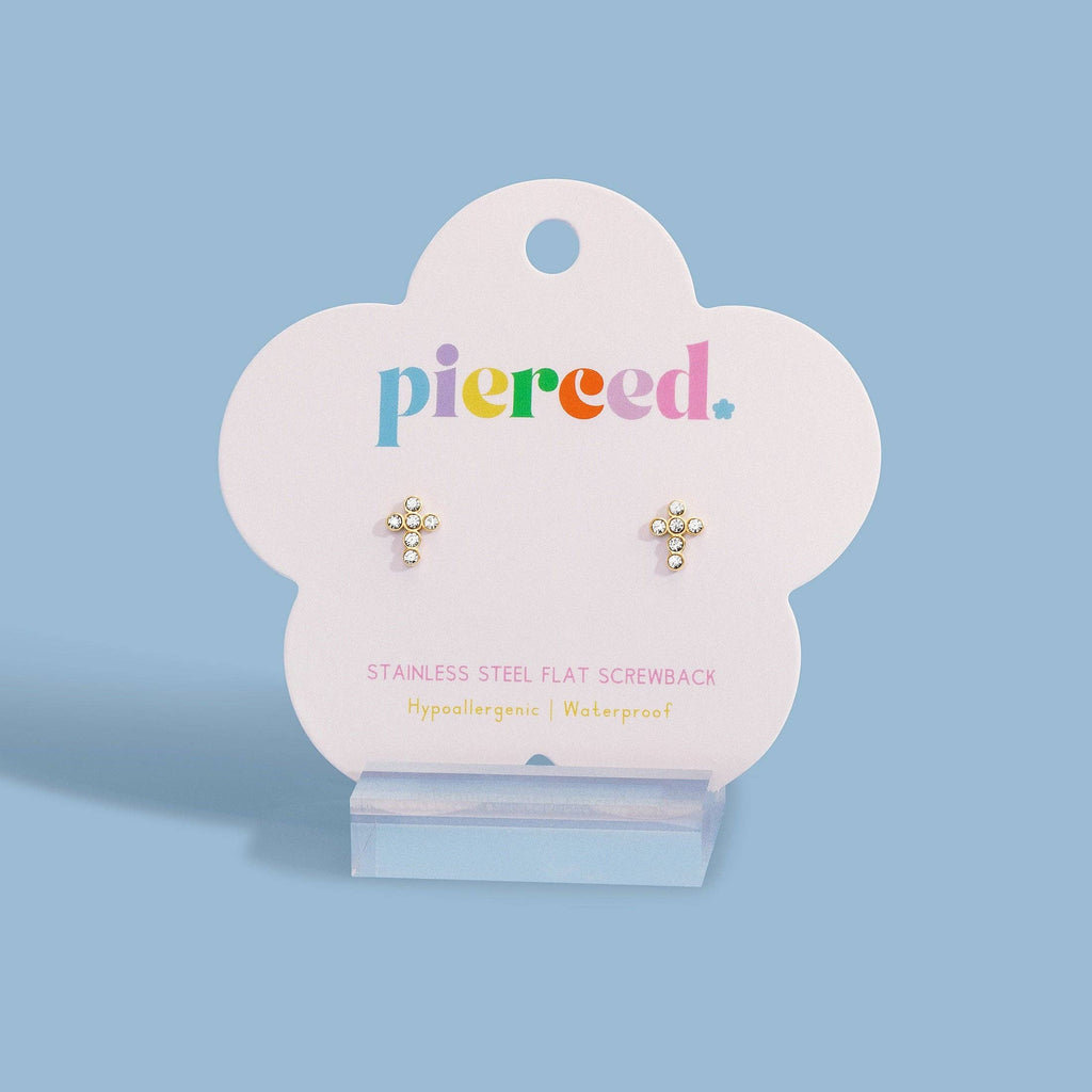 A pair of small gold flat screwback stud earrings displayed on a white cloud-shaped Pierced jewelry card, standing on a clear acrylic stand against a light blue background.