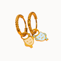 A pair of gold huggie hoop earrings with dangling enamel character charms, one in yellow and one in light blue, on a plain white background.