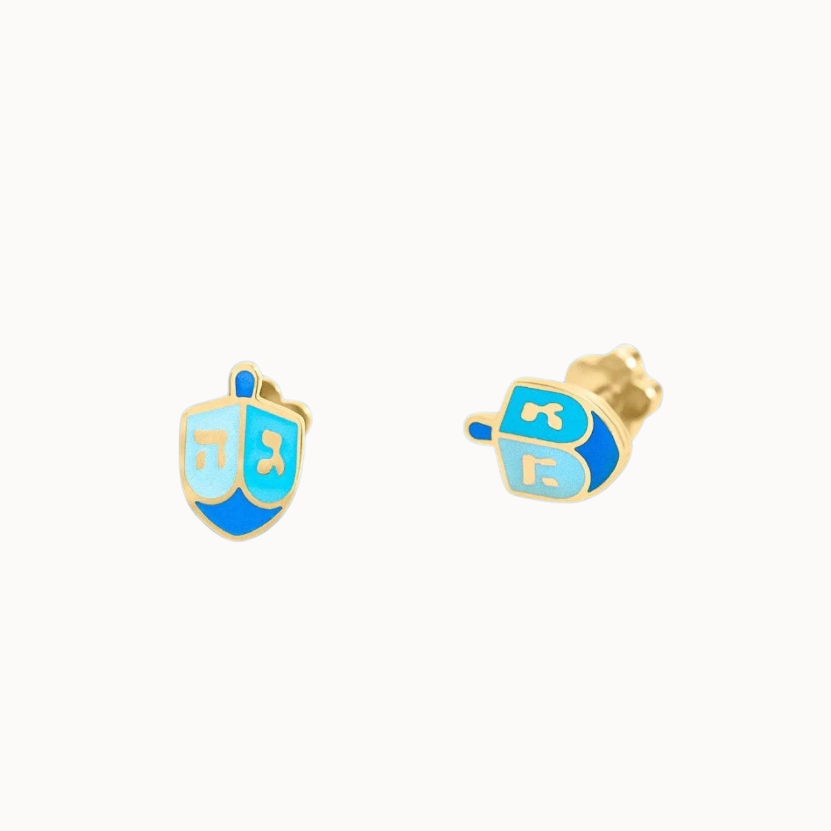 A pair of gold-tone stud earrings shaped like a dreidel, featuring light blue and royal blue enamel sections with gold lettering, shown on a plain off-white background.
