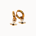Gold huggie hoop earrings with a dangling golf club and golf ball charm, shown on a plain off-white background.