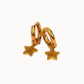 A pair of gold huggie hoop earrings with dangling glittery gold star charms, shown on a plain off-white background.