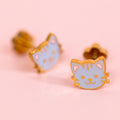 Cat-shaped earrings on a pink background