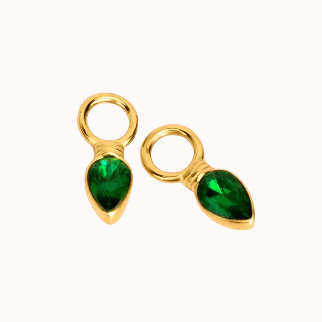Two gold teardrop-shaped charms with faceted green gemstones, displayed on a clean white background.