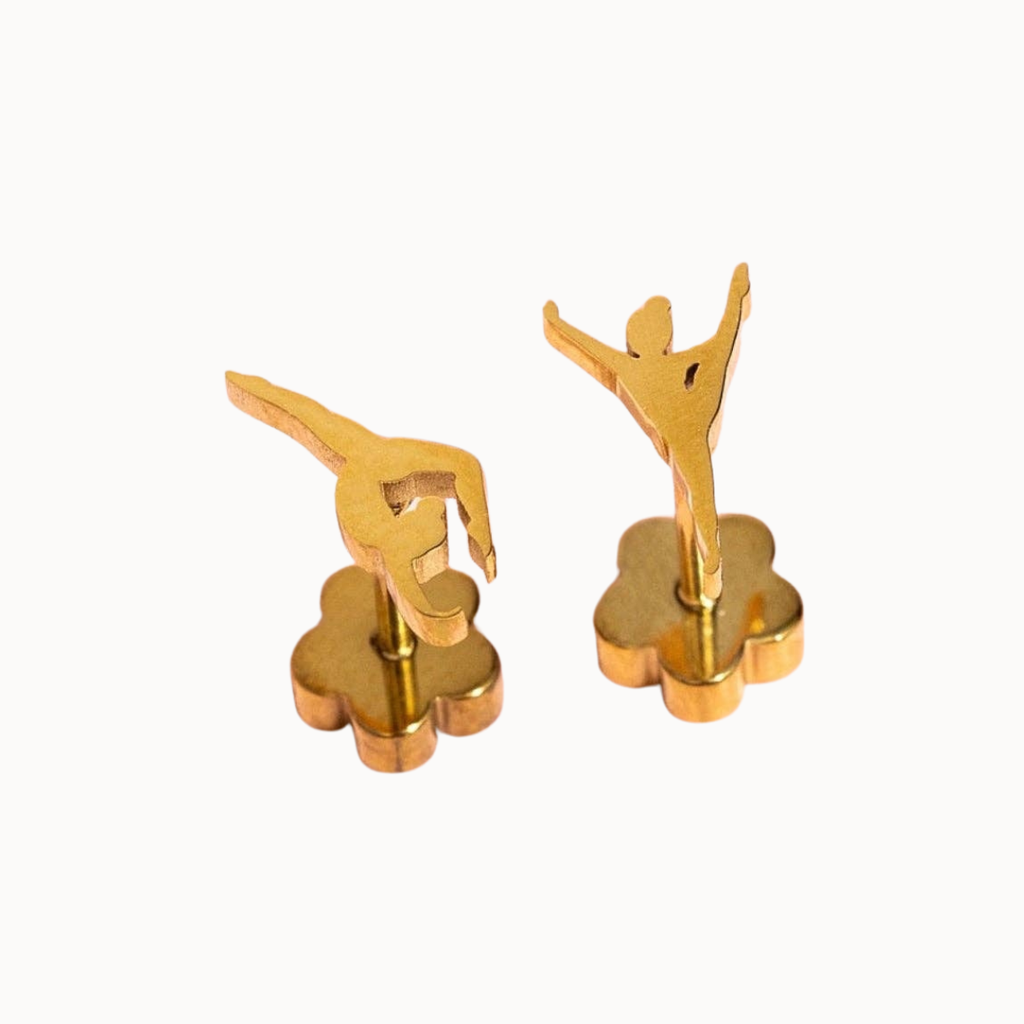 A pair of gold-toned cufflinks shaped like stylized ballerina figures standing on flower-shaped bases, shown against a plain white background.