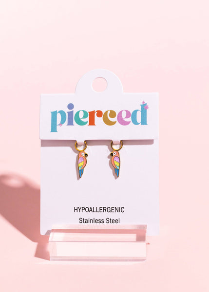 Pair of colorful feather-shaped earrings on a 'pierceed' branded card with pink background