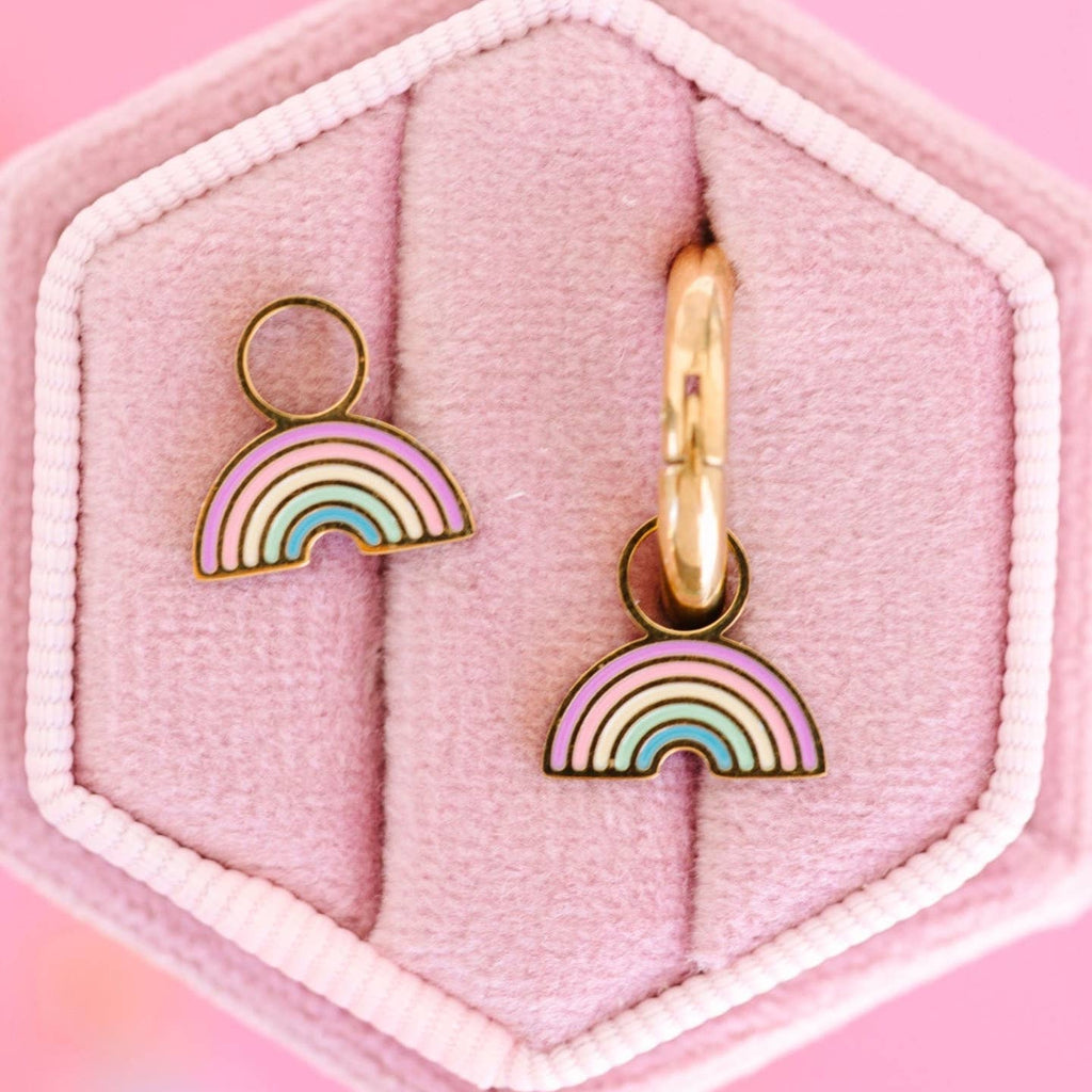 Rainbow-shaped earrings on a pink hexagonal jewelry box