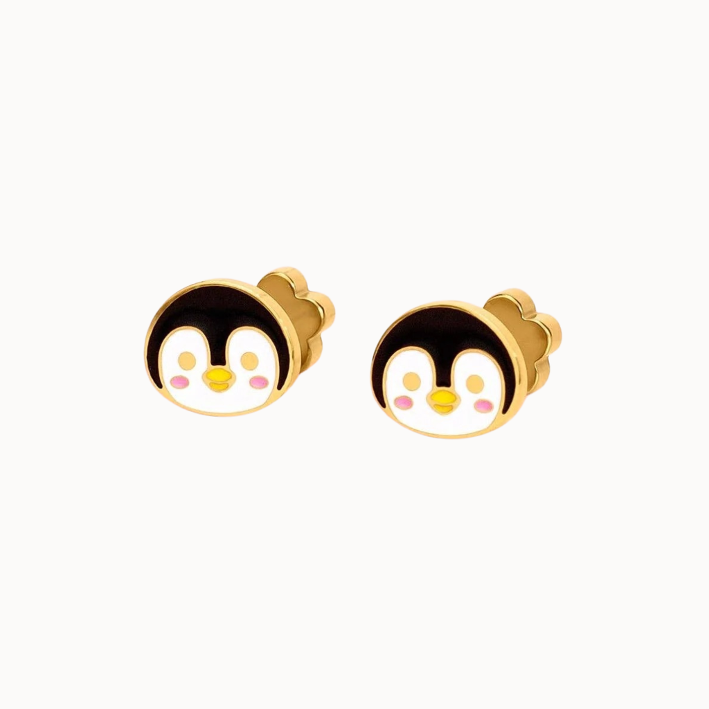 A pair of gold stud earrings featuring cute cartoon penguin faces with black, white, yellow, and pink enamel details, set against a plain white background.