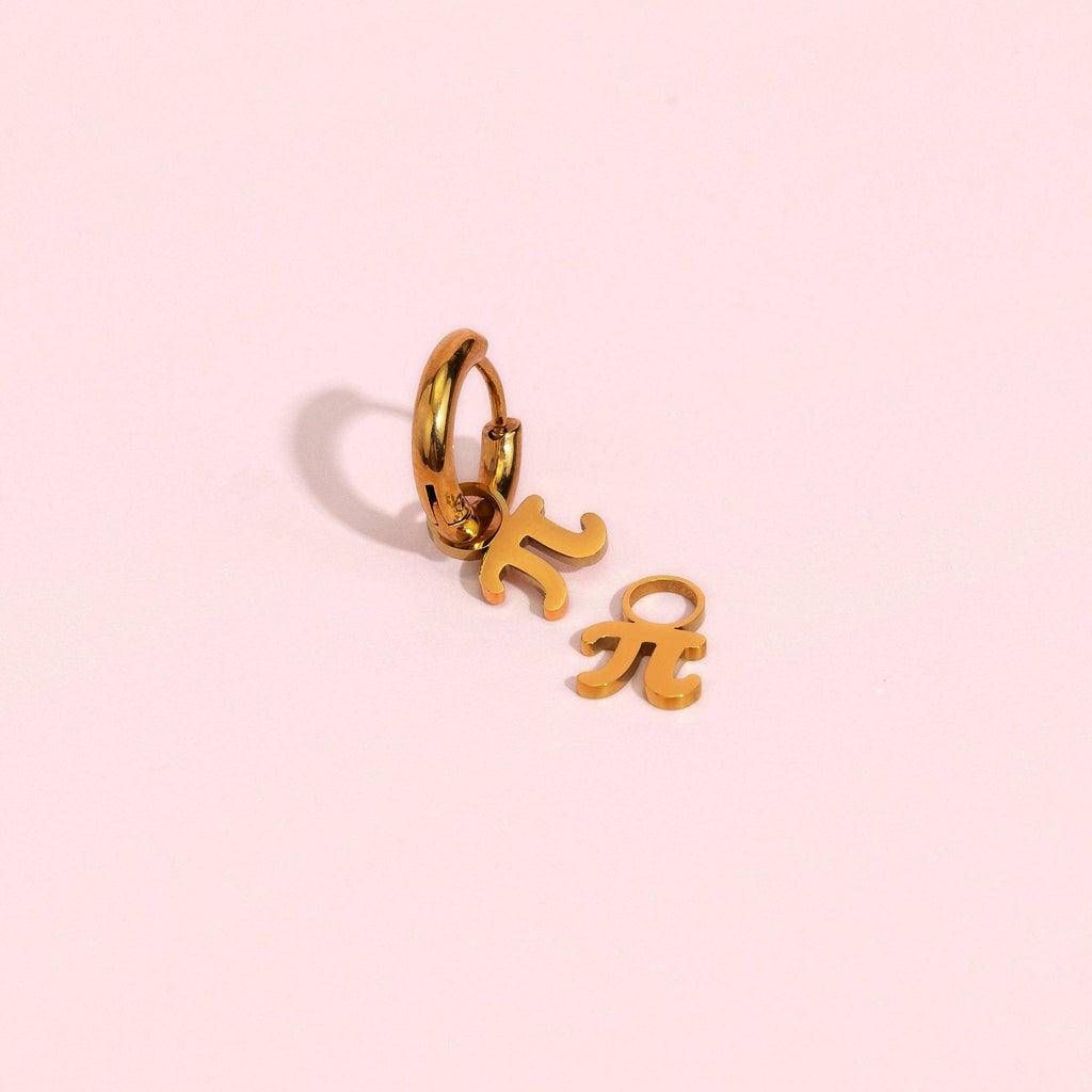 A gold hoop earring with dangling Greek letters Pi (π) and Eta (η), shown on a solid pale pink background.