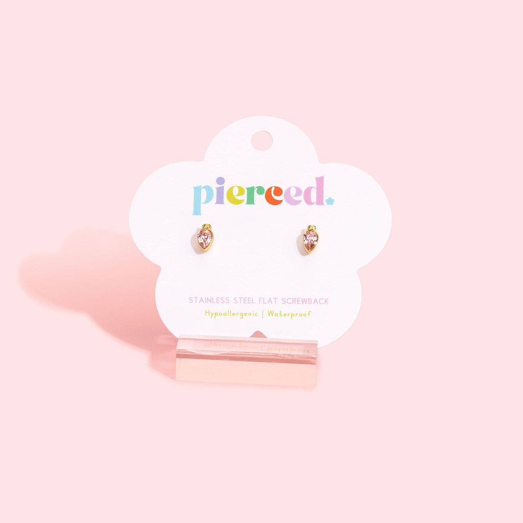 A pair of small flat screwback earrings displayed on a white cloud-shaped card stand against a soft pink background. The card shows the brand name 'pierce.
