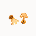 A pair of gold puzzle-piece stud earrings shown from both front and side angles on a clean white background.