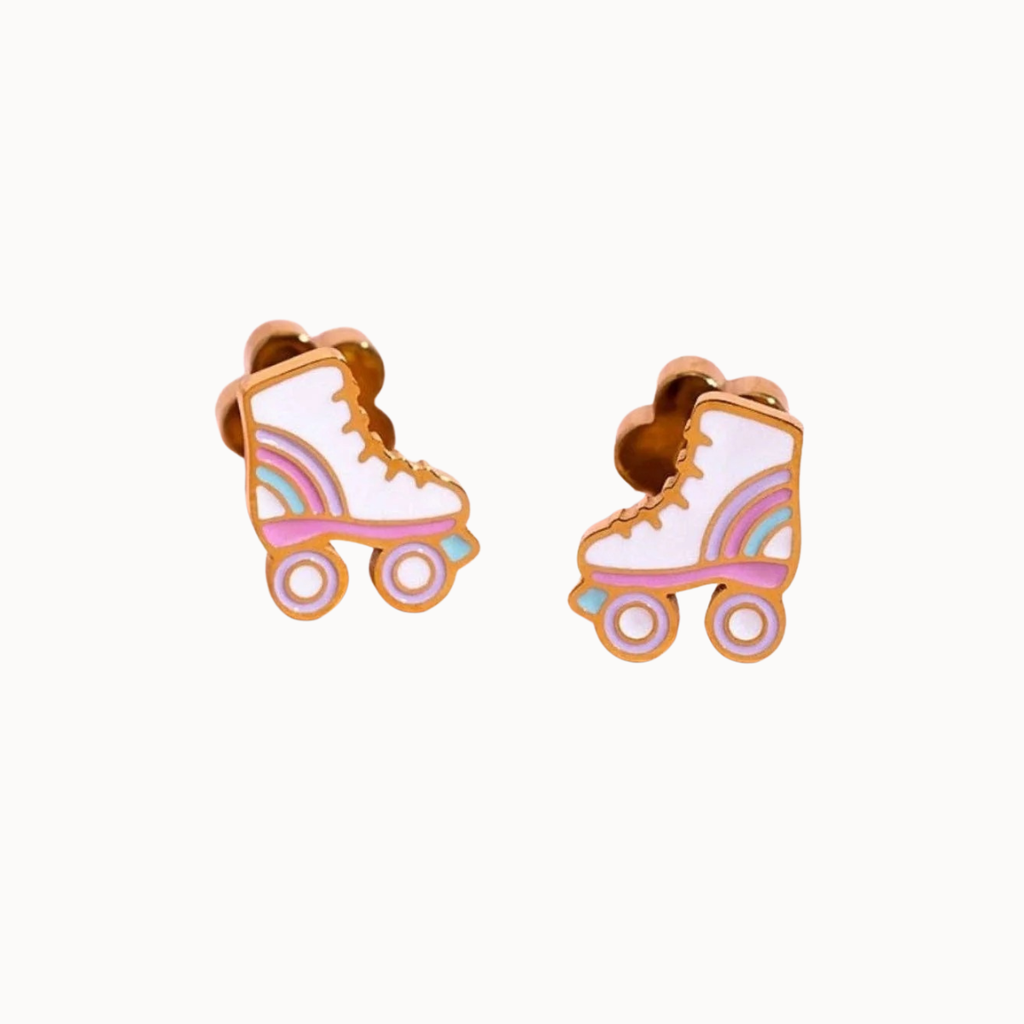 A pair of roller skate stud earrings with a gold-tone metal outline, decorated with pastel rainbow stripes and white enamel on a clean off-white background.