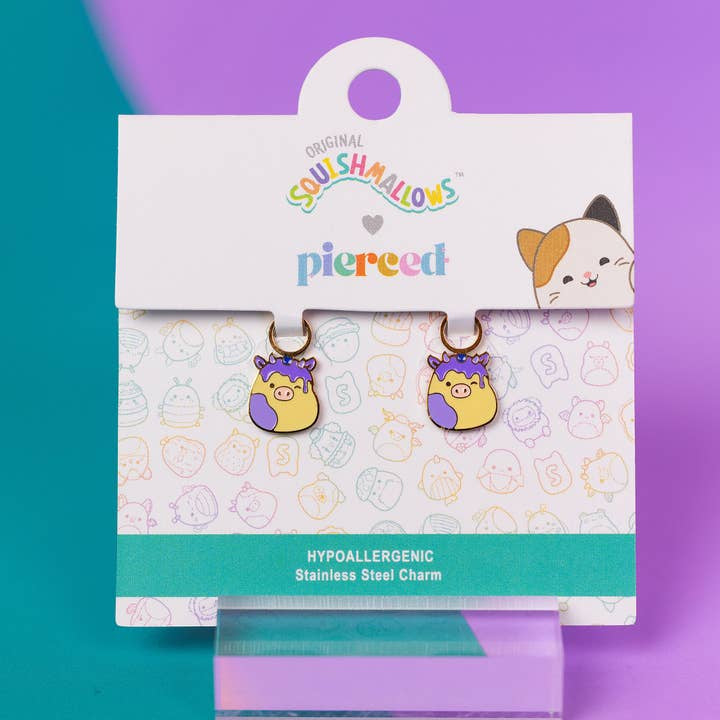 Squishmallows earrings on a branded card with a colorful background