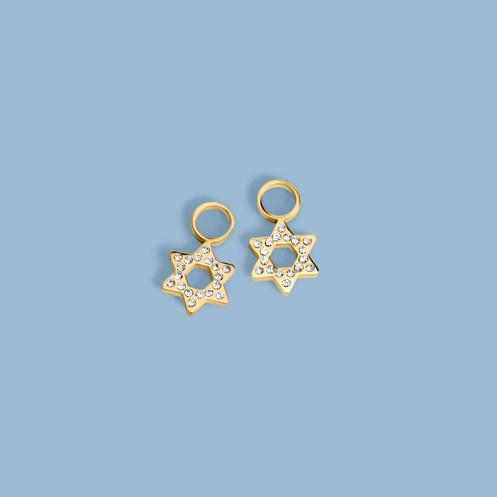 A pair of gold Star of David earrings embellished with clear rhinestones, shown on a clean blue background.