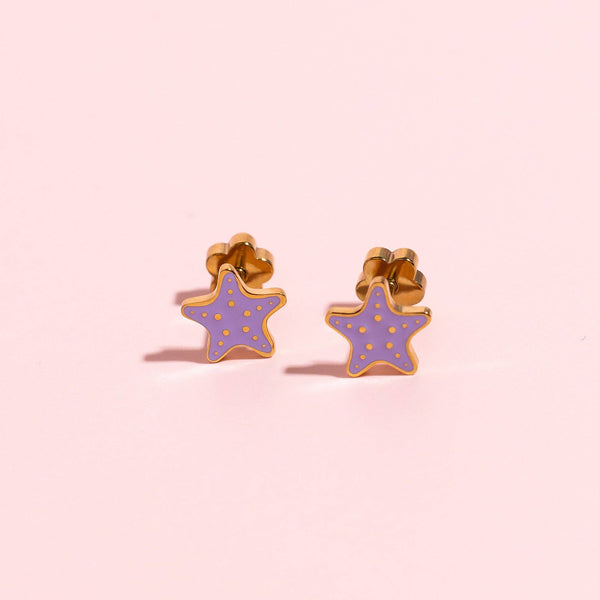 Star-shaped earrings on a pink background