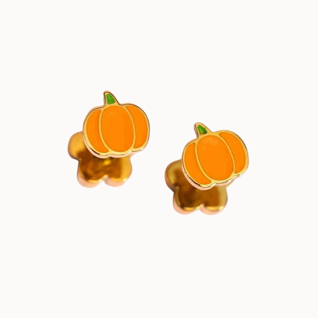 A pair of pumpkin-shaped stud earrings with bright orange enamel, gold-tone metal outlines, and small green stems, displayed on a clean white background.