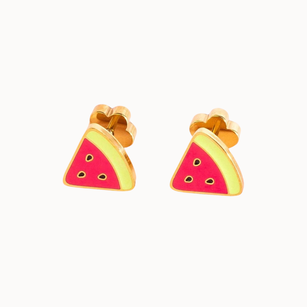 A pair of gold-tone stud earrings shaped like watermelon slices, featuring bright pink-red centers with small black seed details and pale yellow rinds, shown on a plain off-white background.