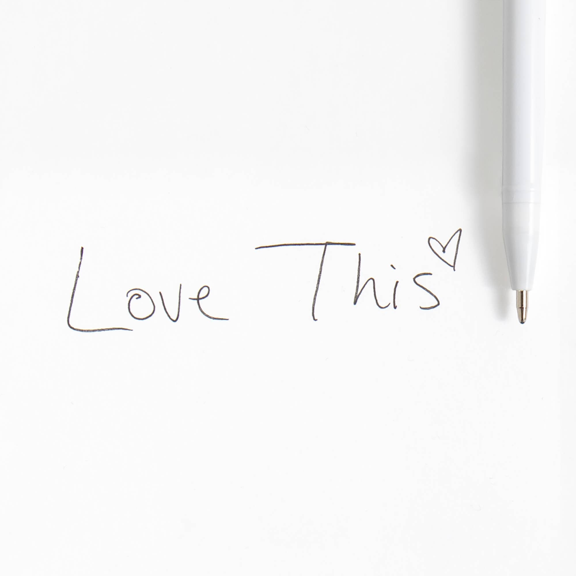 White pen with 'Love This' text on a white background