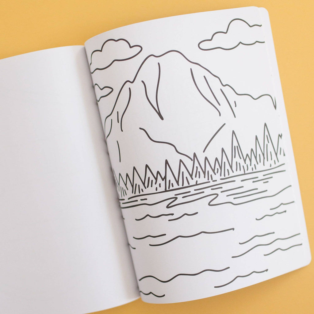 Open book with a mountain and lake illustration on a yellow background