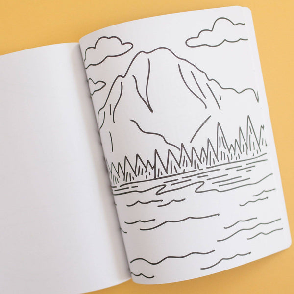Open book with a mountain and lake illustration on a yellow background