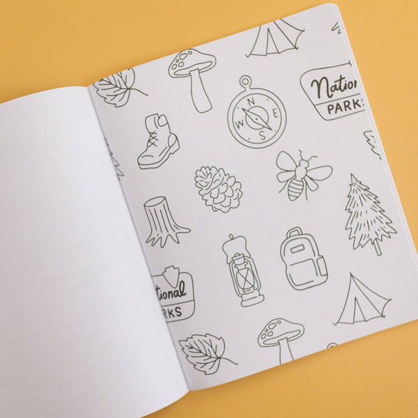Open notebook with nature-themed line drawings on a yellow background