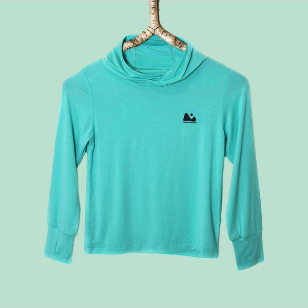 Turquoise long-sleeve shirt with a black logo on a hanger against a light green background