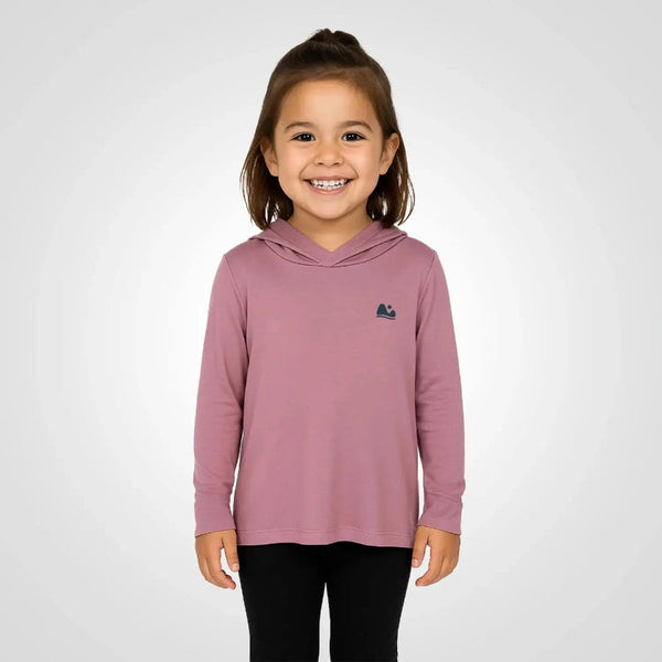 Young girl wearing a pink hoodie with a logo on a white background