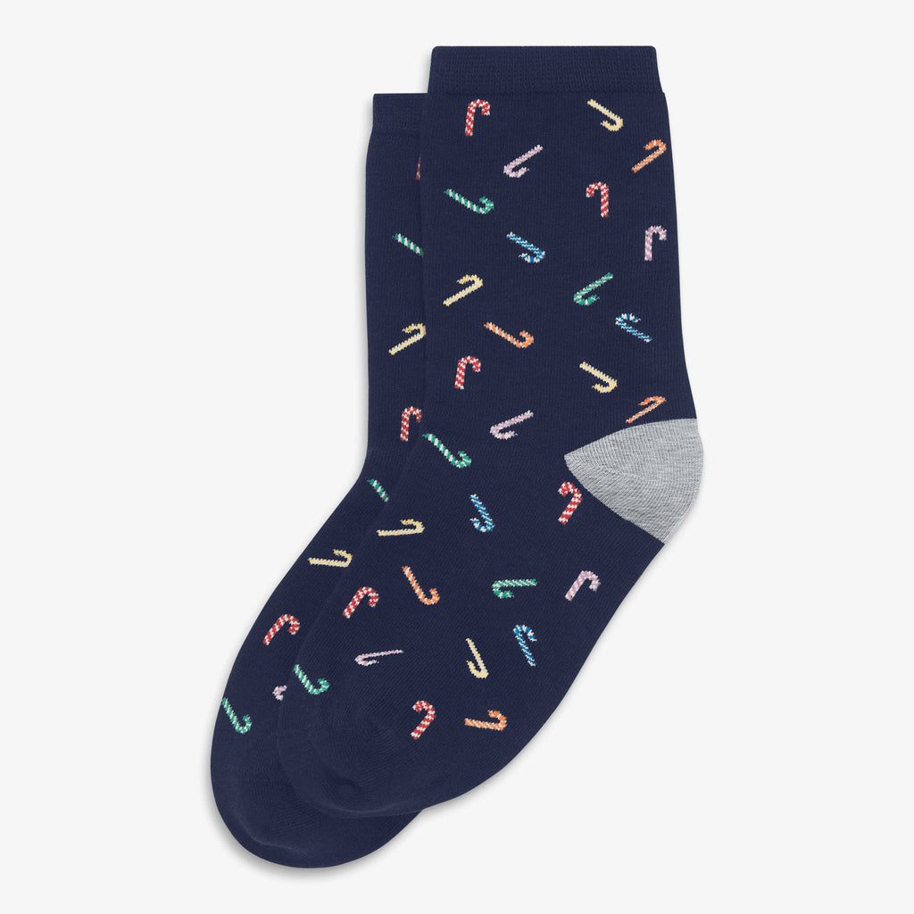A pair of navy blue crew socks with a repeating pattern of small candy canes in pastel colors and a heather gray heel, shown on a light gray background.