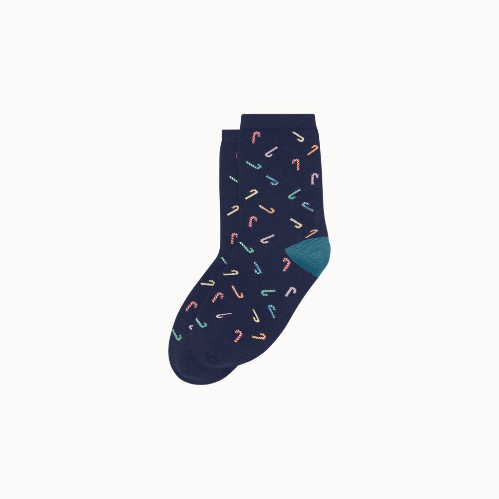 A pair of navy blue crew socks with a repeating pattern of small candy canes in pastel colors and a solid teal heel, shown on a light gray background.