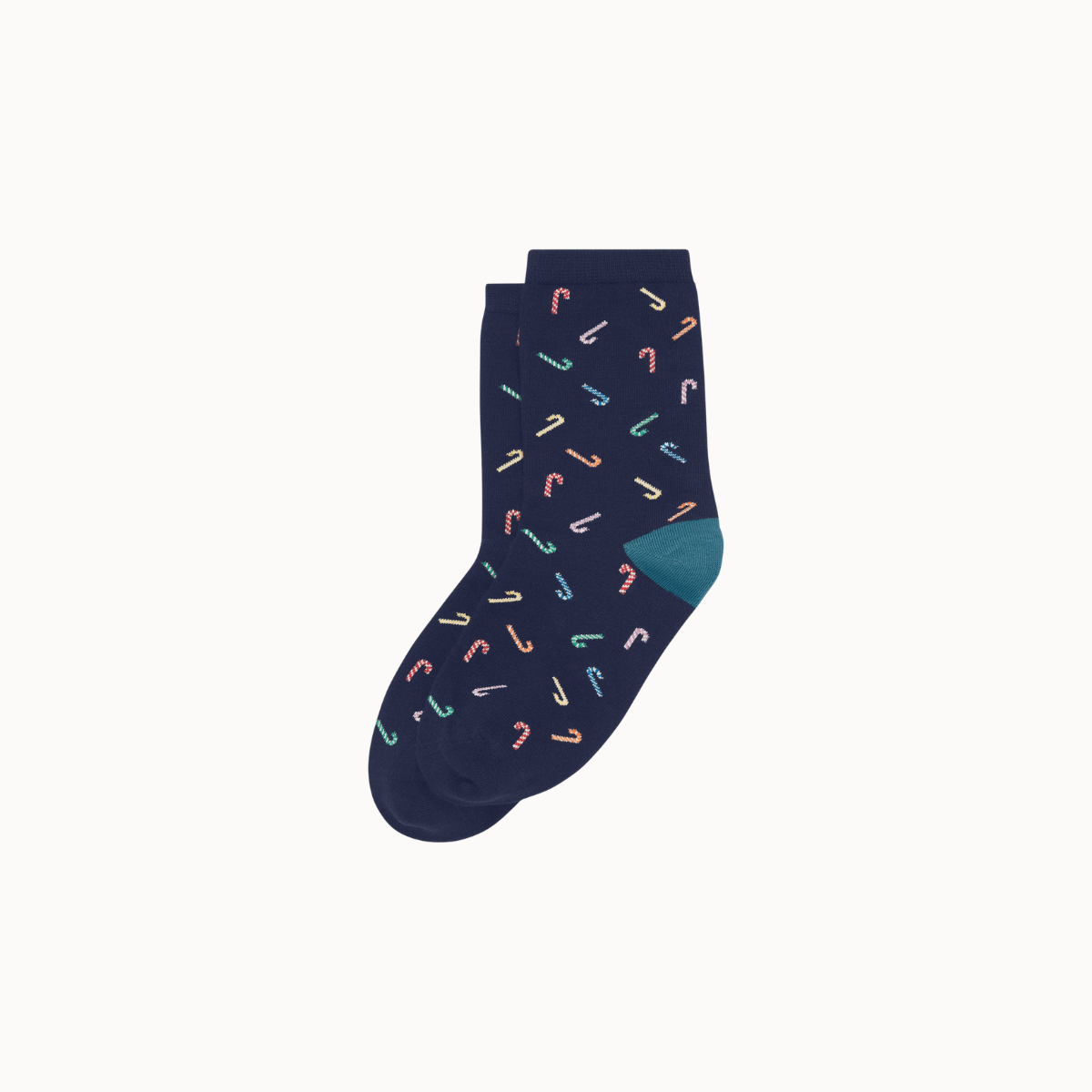 A pair of navy blue crew socks with a repeating pattern of small candy canes in pastel colors and a solid teal heel, shown on a light gray background.