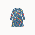 Blue fabric dress with a colorful floral and fruit print, including yellow flowers, green leaves, a red apple, and white dots, finished with a button closure at the neckline on a white background.