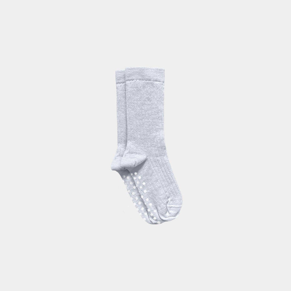 A pair of light gray ribbed socks with white grip dots on the soles, shown against a solid light gray background.