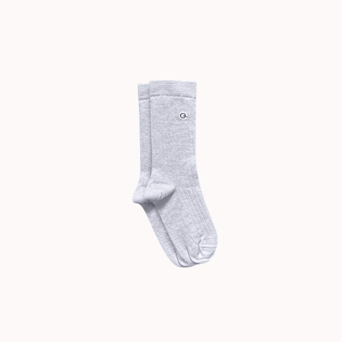 A pair of light gray ribbed socks with shown against a solid light gray background.