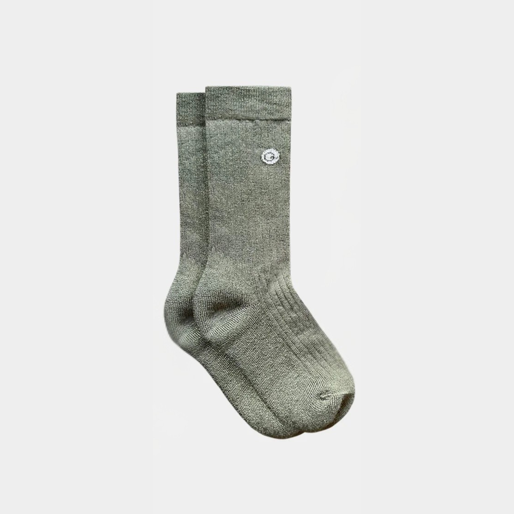 Pair of gray socks on a light gray background