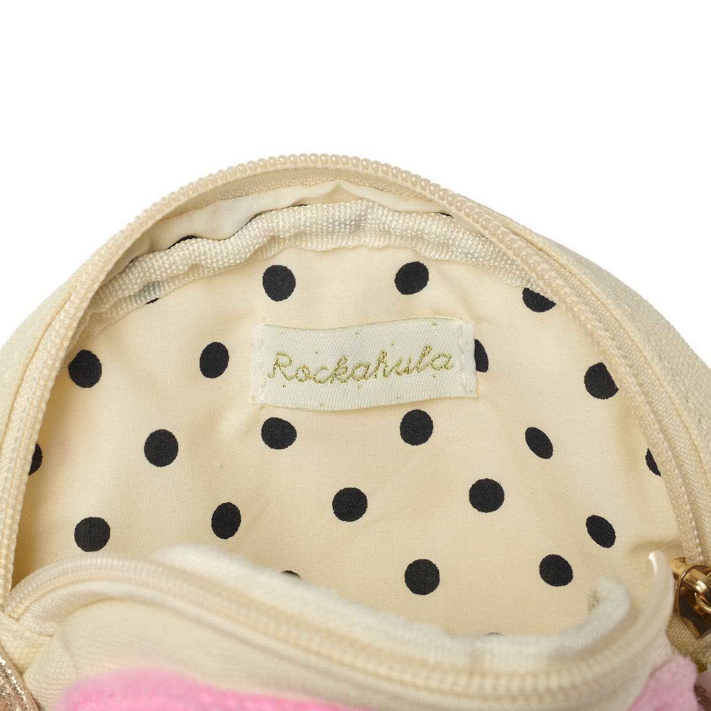 Close-up of a polka dot pouch with 'Rockahula' label on a white background