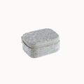 A small rectangular silver glitter jewelry box with a zippered lid, shown on a plain off-white background.