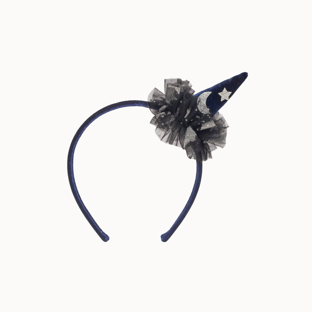 A navy headband featuring a decorative ruffled tulle cluster with a small pointed navy blue horn tip decorated with white stars and a white crescent moon.