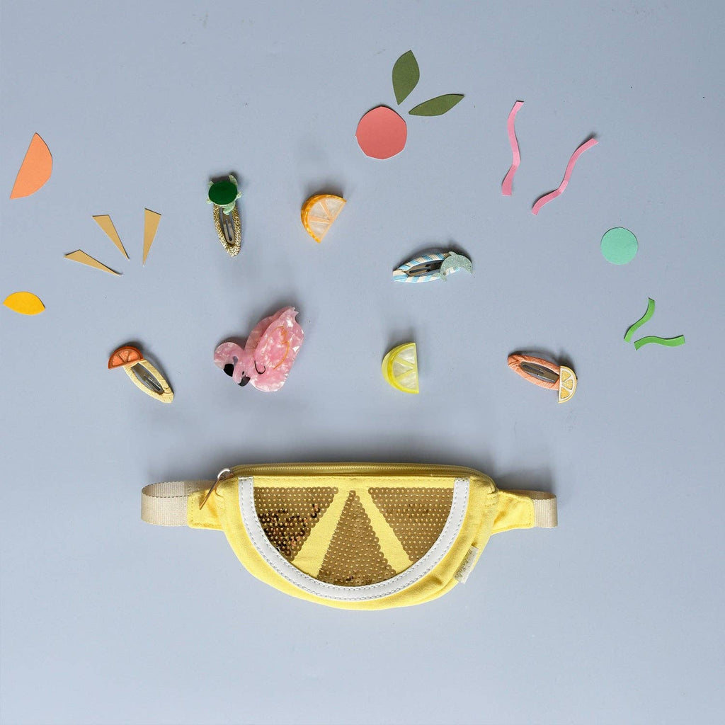 Yellow lemon-shaped bag with decorative elements on a light blue background