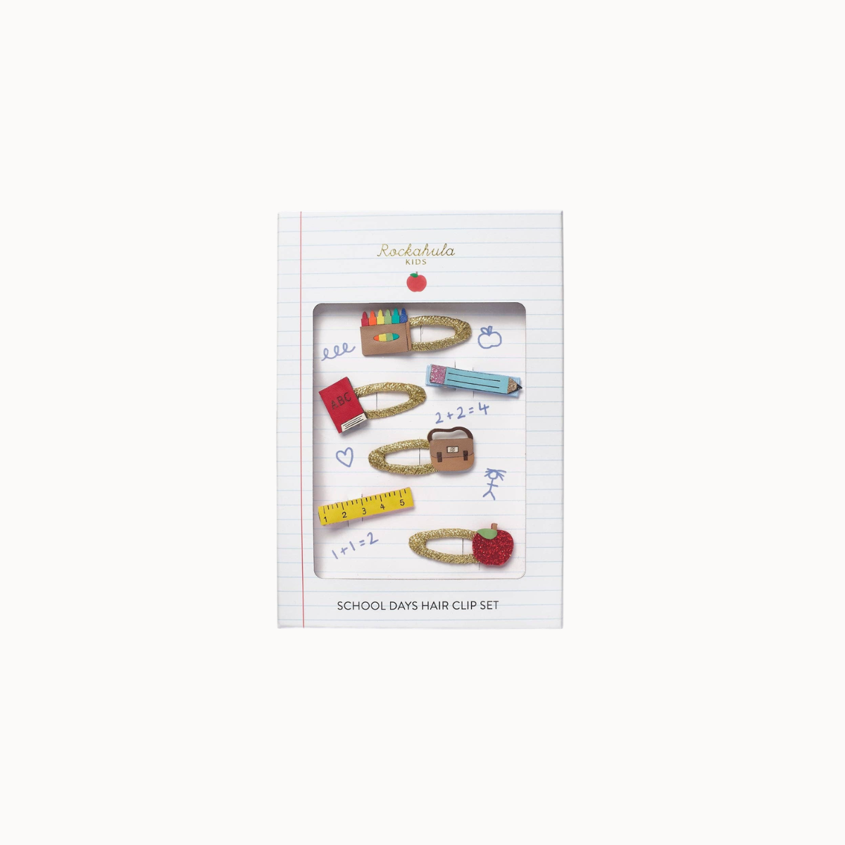 A boxed school-themed hair clip set displayed on a white background. The package is labeled 'Rocknroller KIDS' and 'SCHOOL DAYS HAIR CLIP SET,' showing several gold-toned clips decorated with school supplies like a pencil, ruler, notebook, and apple.