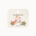 A children's ring set by Rockahula on a cream display card. The set includes a central pastel pink unicorn charm with a gold horn and rainbow mane, flanked by two gold glitter star charms with pink, blue, and green striped tails.