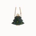 A dark green Christmas tree-shaped purse with a gold star on top, decorated with small multicolored pom-pom lights, and suspended by thin gold straps against a plain white background.