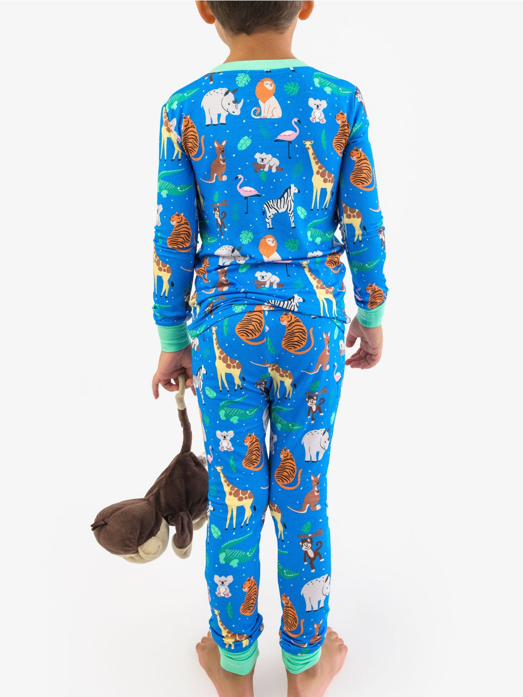 Child wearing blue pajamas with animal print on a white background