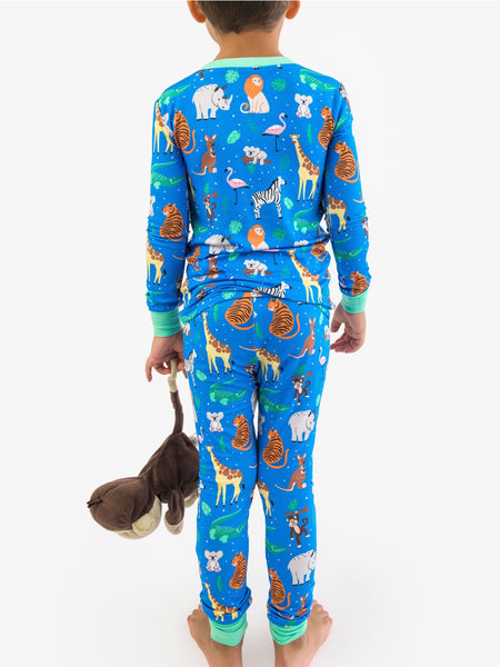 Child wearing blue pajamas with animal print on a white background