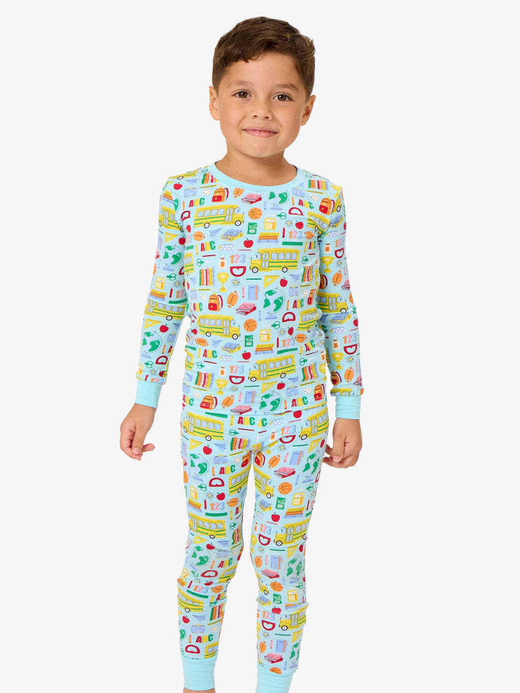 Child wearing a colorful pajama set with various graphics on a white background